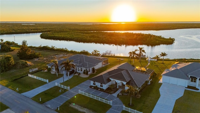 aerial view at dusk with a water view