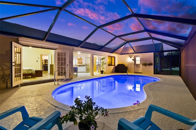 outdoor pool featuring a lanai and a patio area