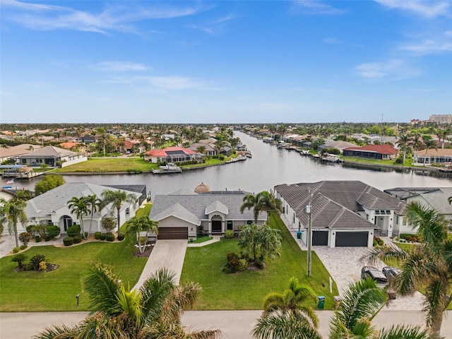 birds eye view of property with a water view and a residential view