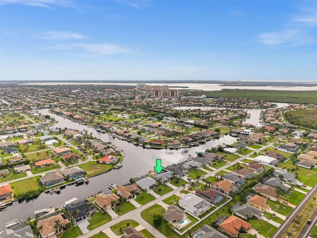 drone / aerial view with a water view and a residential view