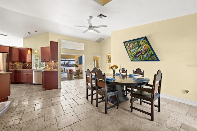 dining room featuring baseboards, visible vents, ceiling fan, and stone tile flooring