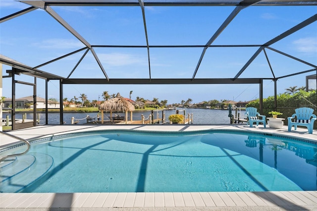 pool with a lanai, a water view, and a patio