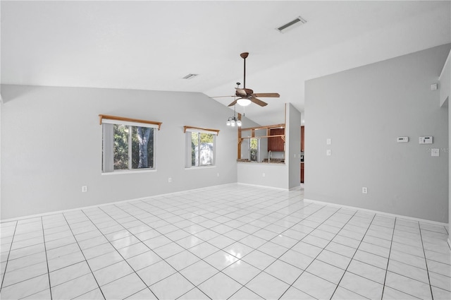 unfurnished living room with ceiling fan, light tile patterned floors, and vaulted ceiling