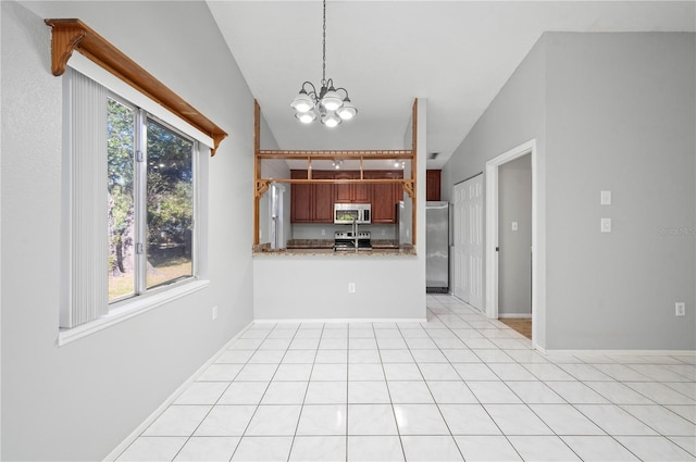 kitchen featuring decorative light fixtures, vaulted ceiling, kitchen peninsula, appliances with stainless steel finishes, and a chandelier