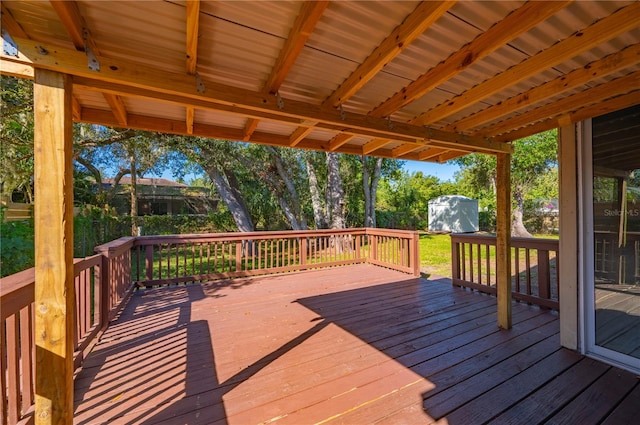 wooden terrace with a storage shed