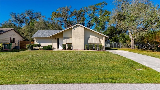 ranch-style home with cooling unit and a front lawn