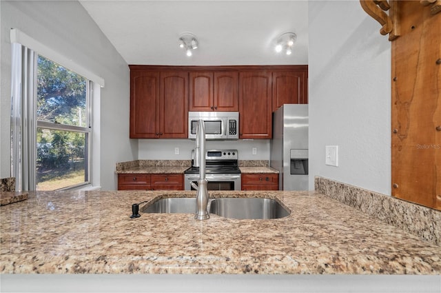 kitchen featuring light stone countertops and appliances with stainless steel finishes