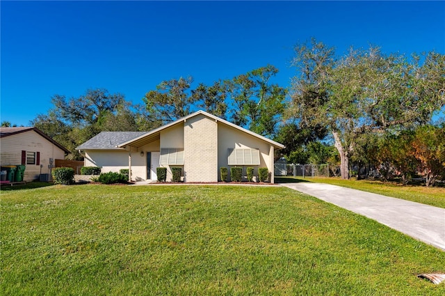 ranch-style house with a front lawn and central AC