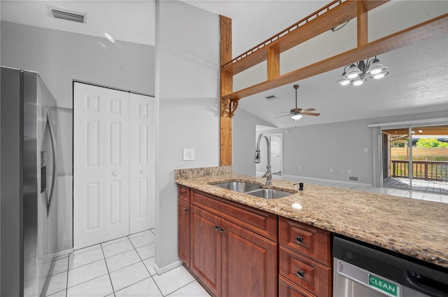 kitchen with ceiling fan with notable chandelier, light stone countertops, appliances with stainless steel finishes, sink, and light tile patterned flooring