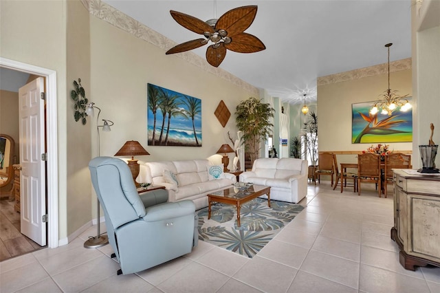 living room with light tile patterned floors and ceiling fan with notable chandelier