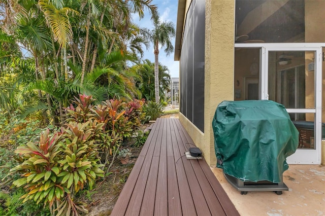 wooden terrace featuring area for grilling