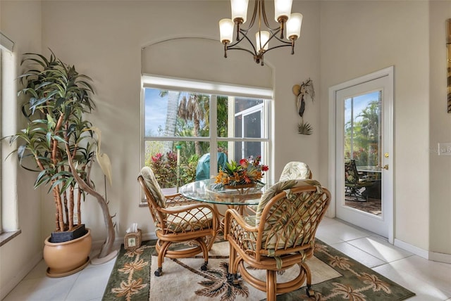 dining space featuring light tile patterned floors, a wealth of natural light, and an inviting chandelier