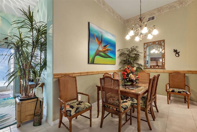 tiled dining area with an inviting chandelier