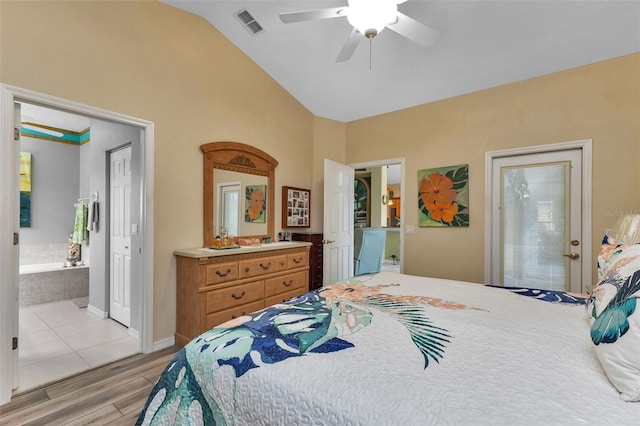 bedroom with vaulted ceiling, ensuite bath, light hardwood / wood-style flooring, and ceiling fan