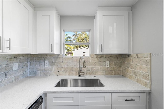 kitchen with dishwasher, decorative backsplash, sink, and white cabinets