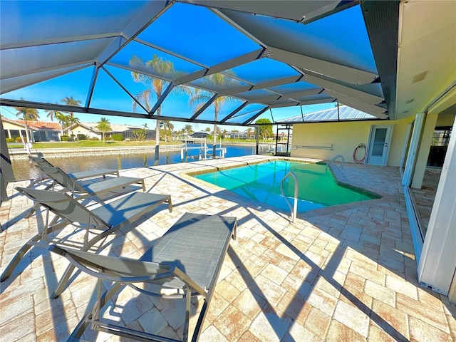 view of swimming pool with glass enclosure, a patio area, and a water view