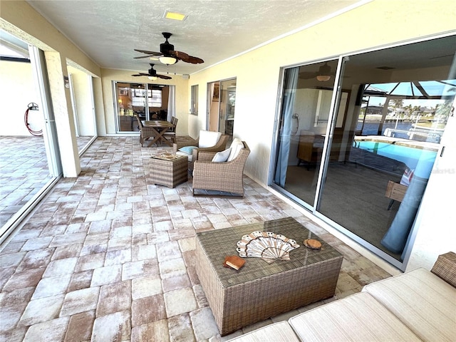 sunroom featuring ceiling fan