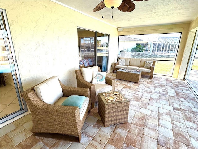 sunroom / solarium with plenty of natural light and ceiling fan