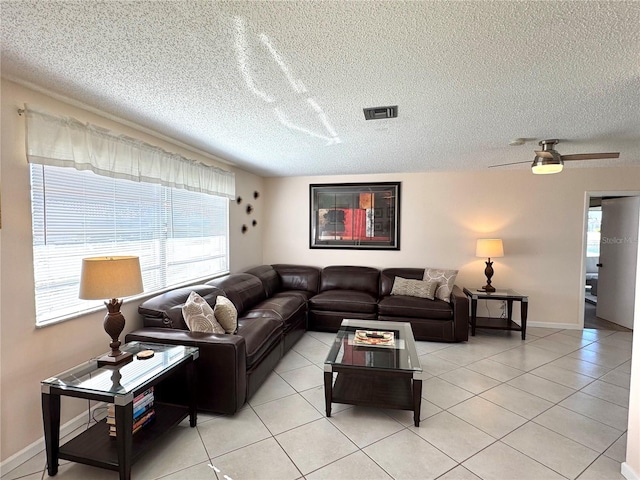 living room featuring light tile patterned flooring and a textured ceiling