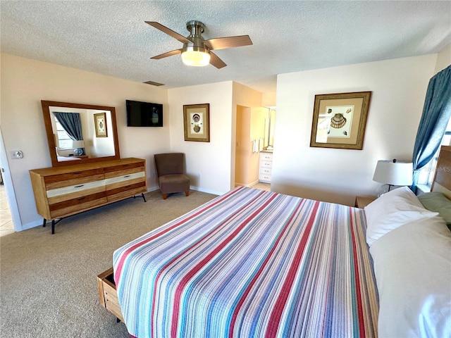 carpeted bedroom featuring ceiling fan and a textured ceiling