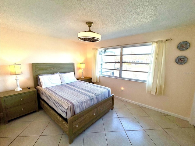 tiled bedroom with a textured ceiling