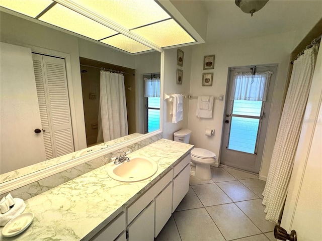 bathroom with tile patterned floors, vanity, and toilet