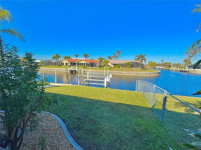 dock area with a yard and a water view