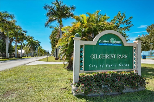 community / neighborhood sign with a yard