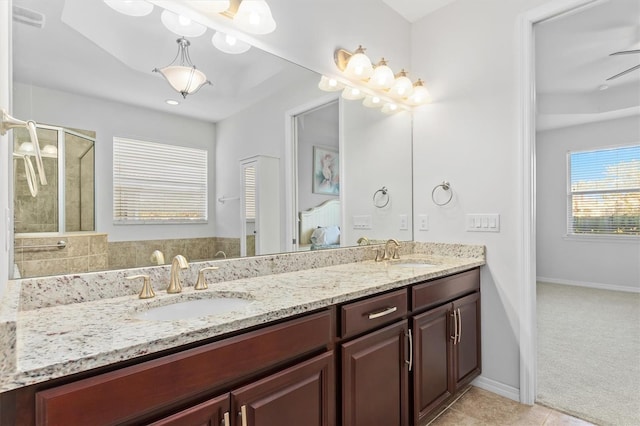 bathroom with tile patterned floors, vanity, ceiling fan, and an enclosed shower