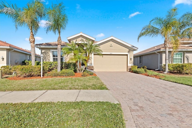 view of front of home featuring a front lawn and a garage