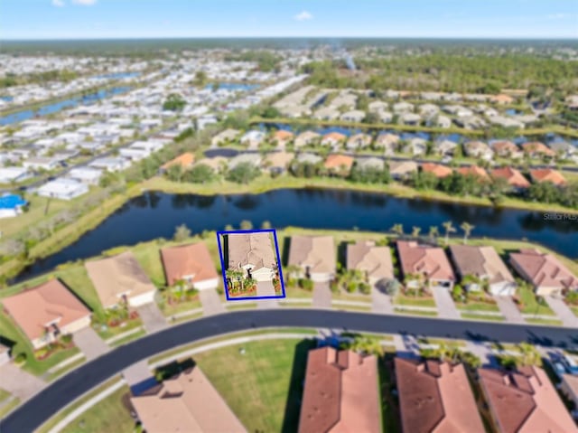 drone / aerial view with a residential view and a water view