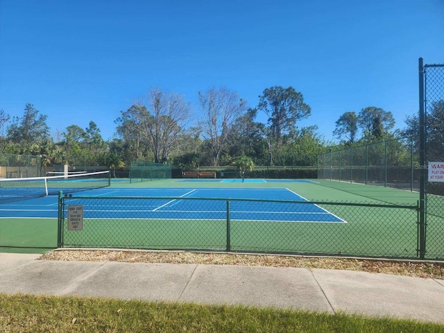 view of tennis court with fence