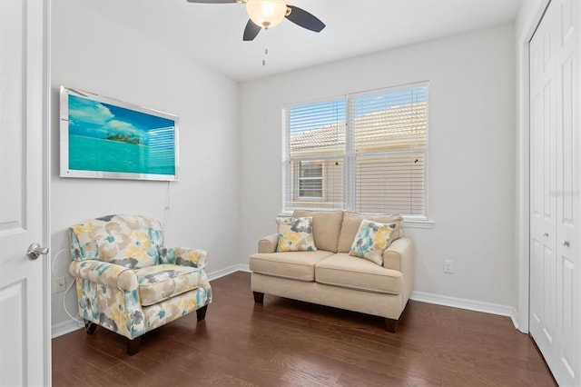 living area with baseboards and wood finished floors