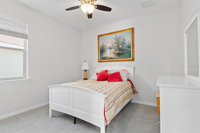 carpeted bedroom featuring visible vents, a ceiling fan, and baseboards