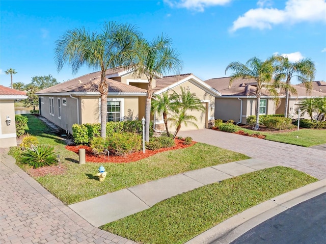 view of front of property featuring an attached garage, stucco siding, a front lawn, a tiled roof, and decorative driveway