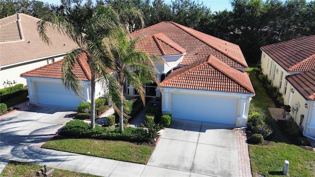 mediterranean / spanish-style home with a garage