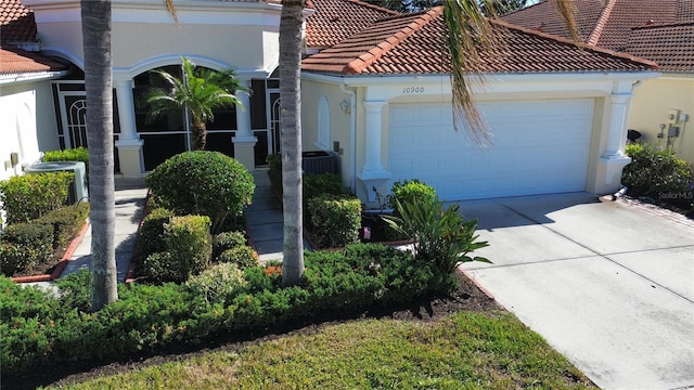 view of home's exterior featuring a garage and central AC