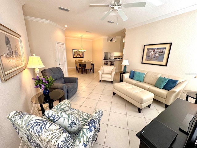 living room featuring ceiling fan, ornamental molding, and light tile patterned flooring