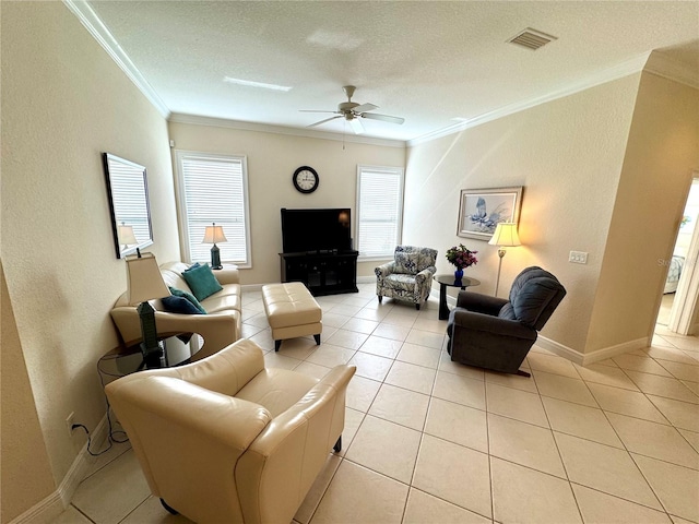 tiled living room with ceiling fan, ornamental molding, and a textured ceiling