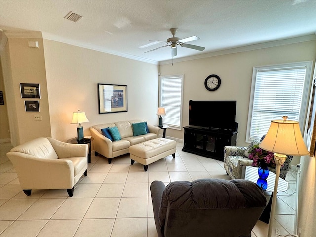 living room with a textured ceiling, ceiling fan, crown molding, and light tile patterned flooring