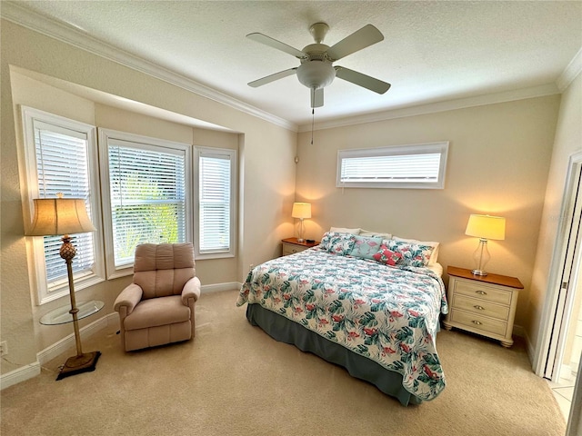 carpeted bedroom featuring a textured ceiling, ceiling fan, and crown molding