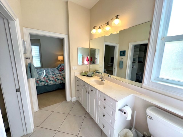 bathroom featuring tile patterned flooring, vanity, and toilet