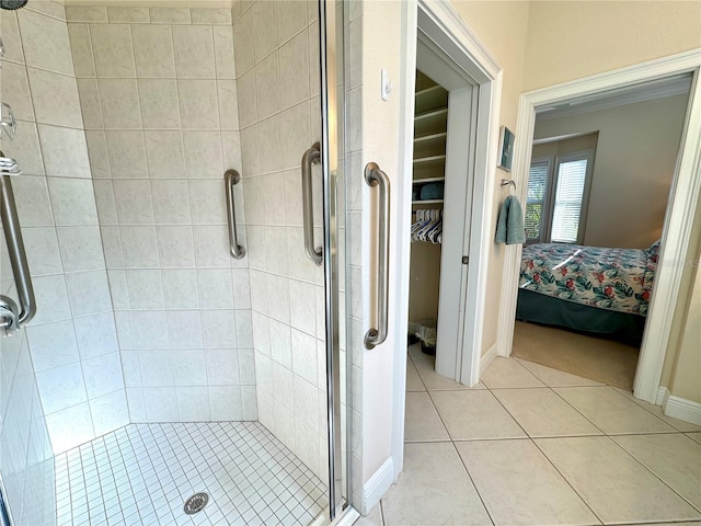 bathroom featuring a shower with door and tile patterned flooring