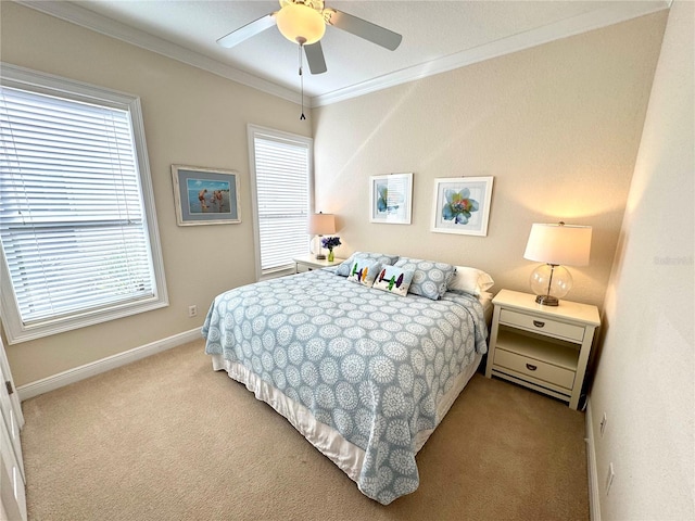 carpeted bedroom with ceiling fan and ornamental molding