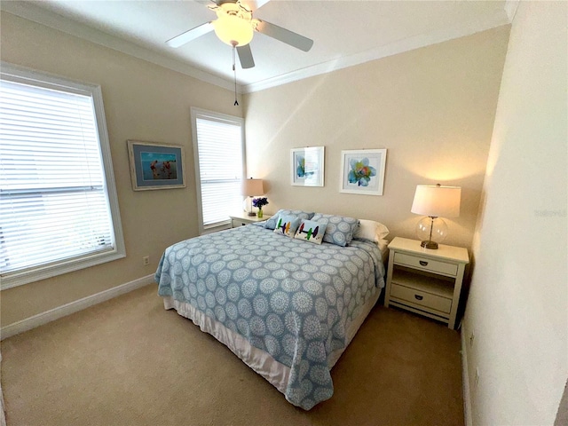 carpeted bedroom with ceiling fan and crown molding