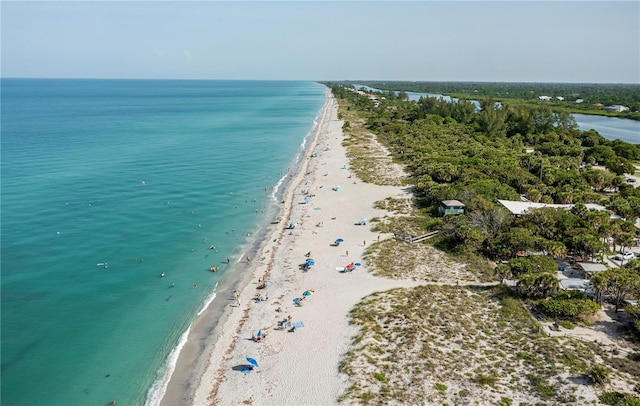 birds eye view of property with a water view and a view of the beach