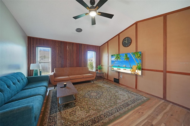 living room featuring hardwood / wood-style flooring, ceiling fan, a wealth of natural light, and vaulted ceiling