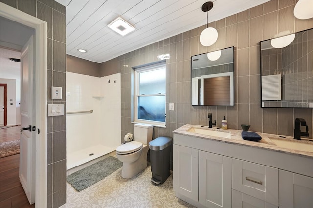 bathroom with hardwood / wood-style flooring, toilet, tile walls, and walk in shower