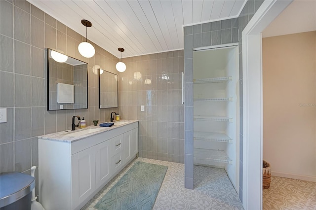 bathroom with vanity and tile walls