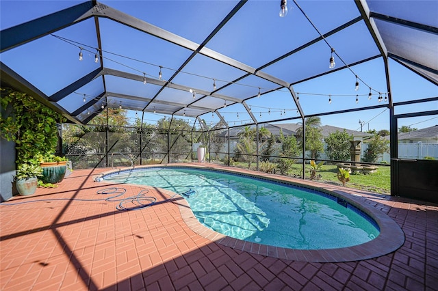 view of swimming pool with a patio area and a lanai